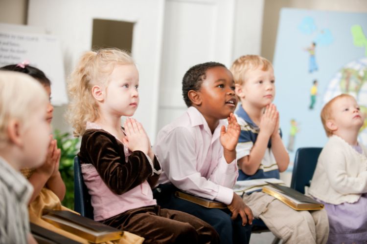 Pre-school children learning to pray