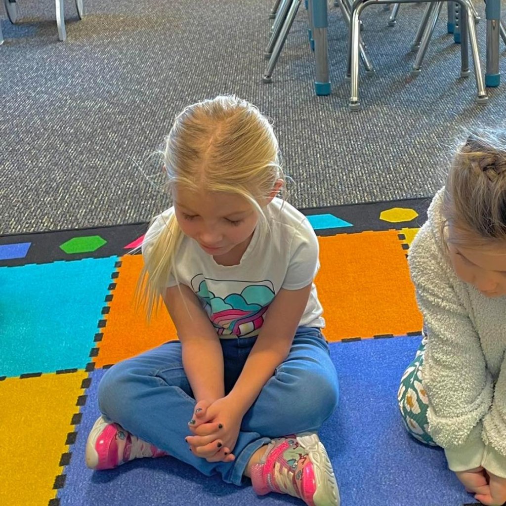 girl praying in preschool